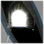 Photo of a tunnel with light at the end of it.