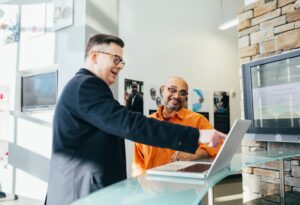 Two business men looking a laptop.