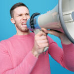 A man yelling into a megaphone.