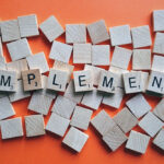 The word Implementation in scrabble peices.