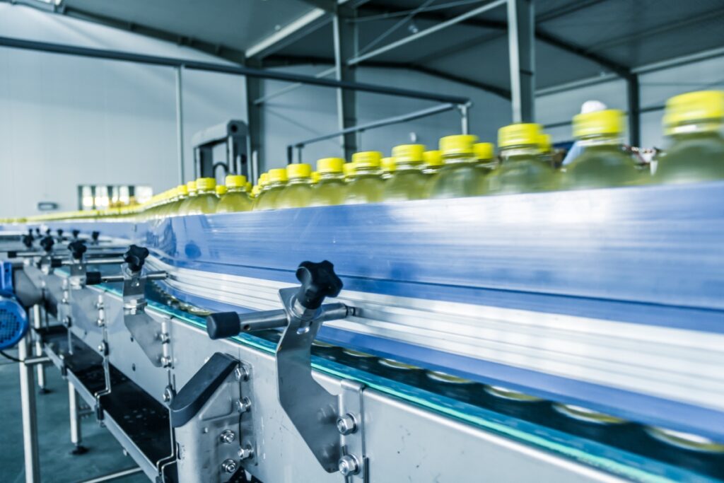 A manufacturing factory line with bottles speeding by.