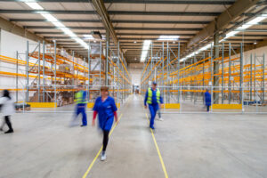 People walking in a warehouse.