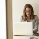 A woman working at a computer.