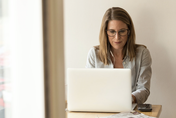 A woman working at a computer.