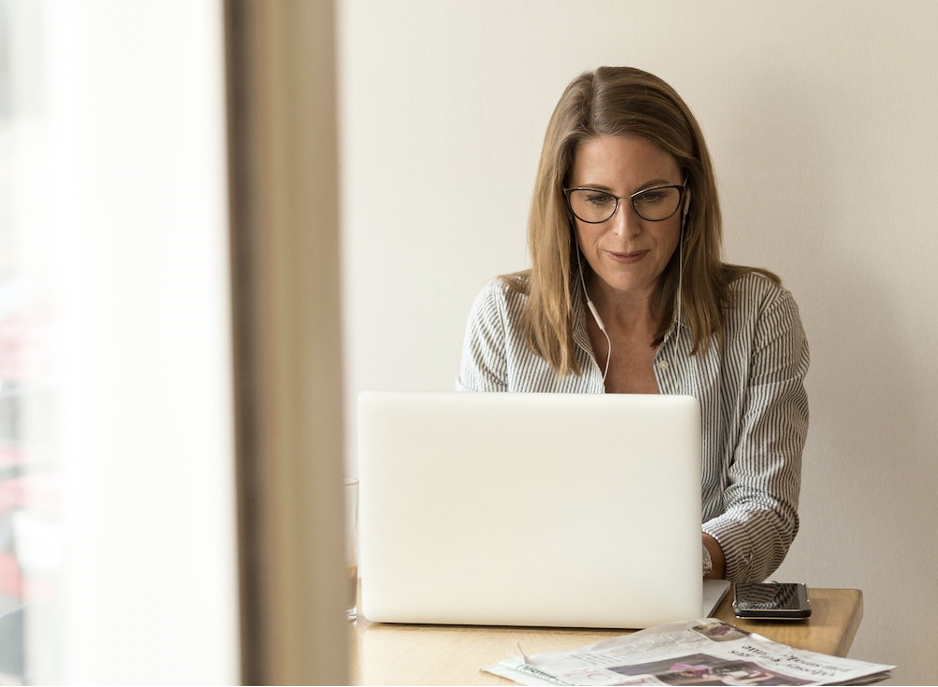 A woman working at a computer.