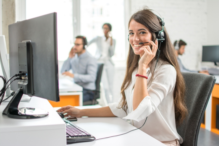 Woman smiling as she works at customer support.