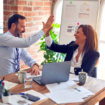 Man and woman high fiving.