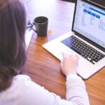 Woman working on laptop.