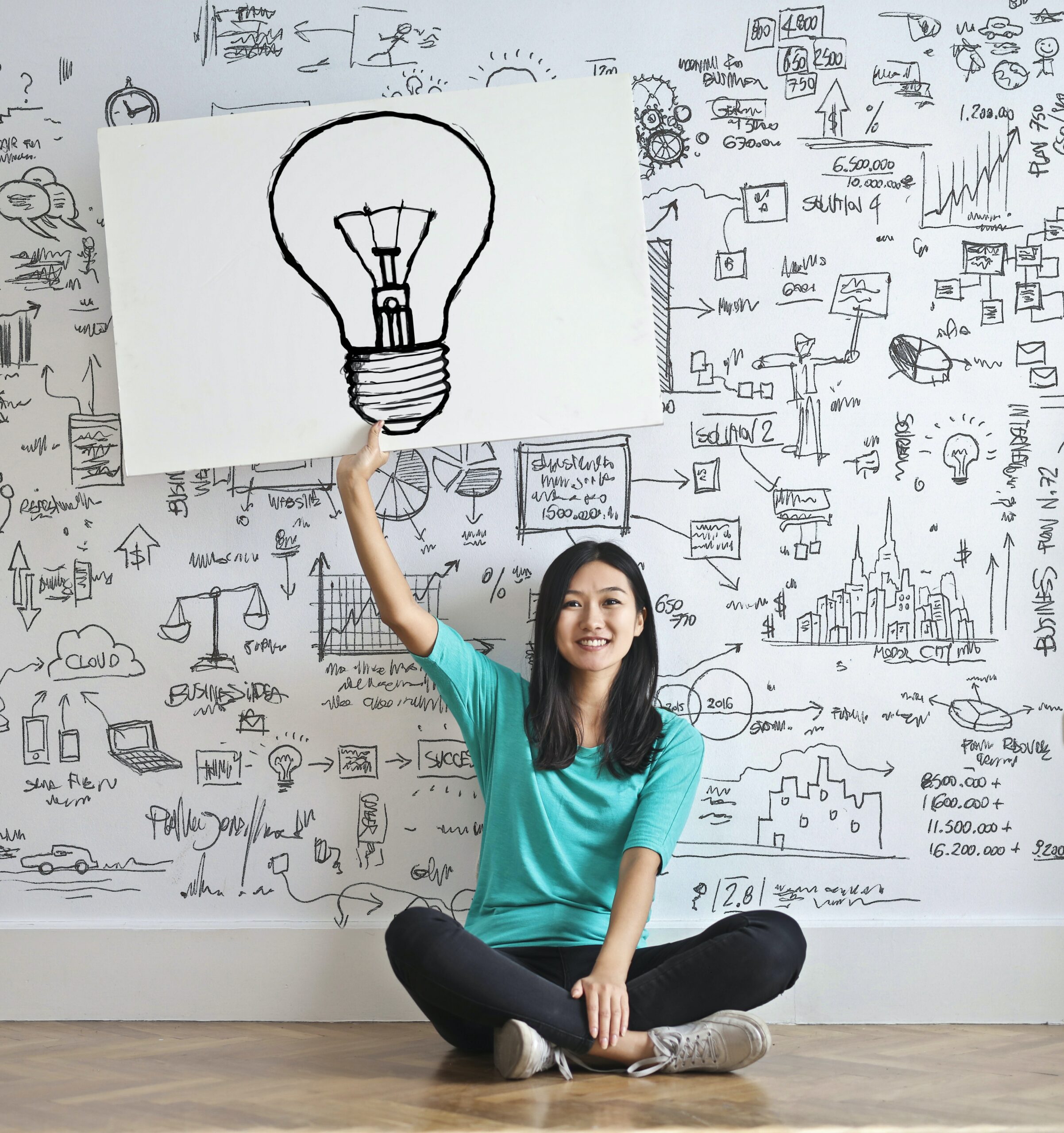 Girl with lightbulb sign.
