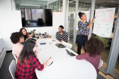 Women of various ethnicities having a business meeting in a conference room.