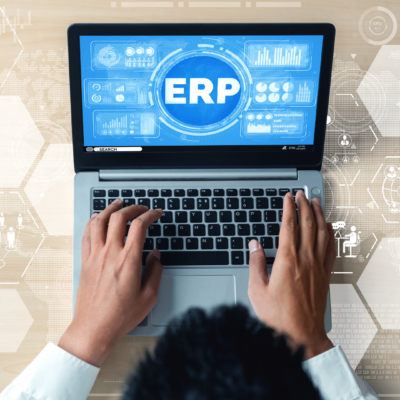 Image of person working on laptop using cloud-based ERP software