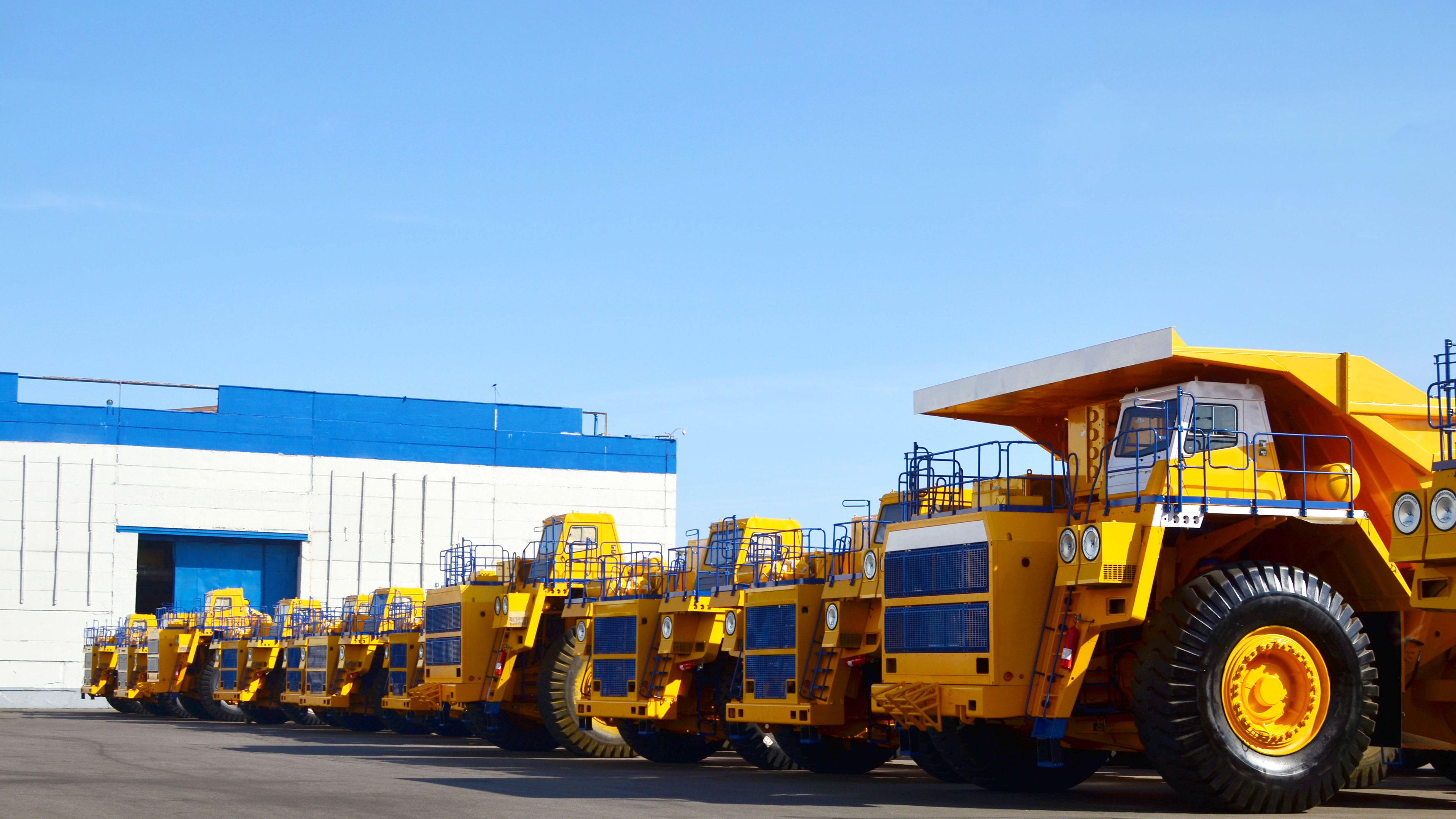 Heavy duty vehicles lined up in a lot, representing the types of businesses that can benefit from Acumatica's specialized solutions.