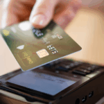 Image of a credit card being read by a scanner with Nuvei processing the payment.