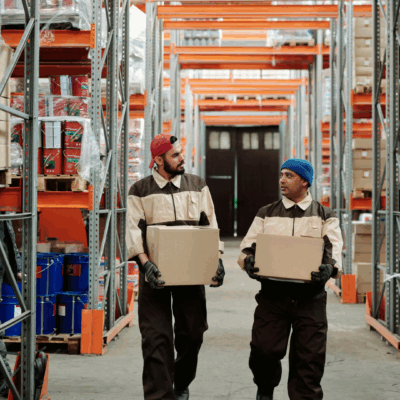 Two people walking through a distribution warehouse that runs efficiently and effectively with Business in a Box.