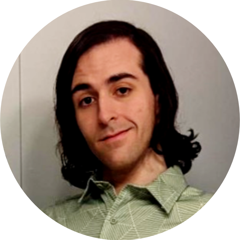 A person with shoulder-length dark hair wearing a light green patterned shirt smiles slightly while looking at the camera, representing the PC Bennett Solutions team. The background is plain and neutral-colored.